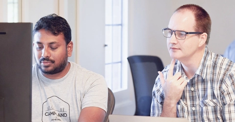 Katalyst engineers collaborating at a computer